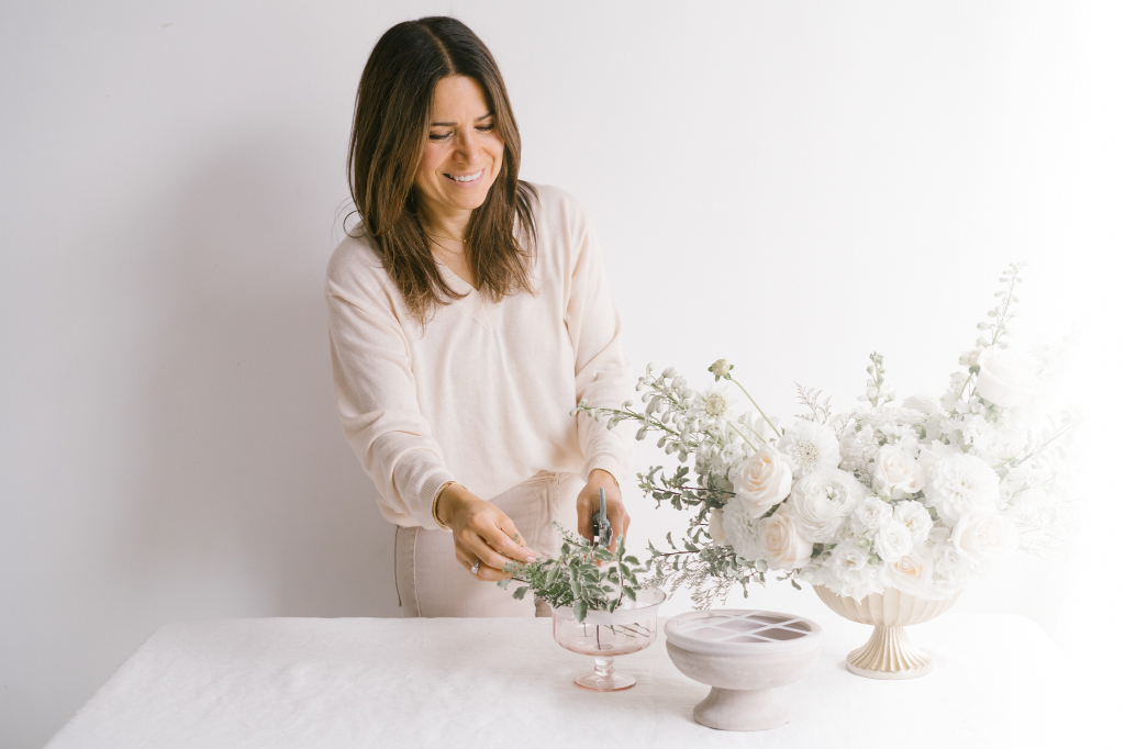 Regine Rivera, founder of Blossom Grid in white against a white background.